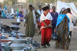 Ethiopians who fled the Tigray conflict buy supplies at a market near the Um Rakuba refugee camp in Sudan's eastern Gedaref state, Jan. 6, 2021.