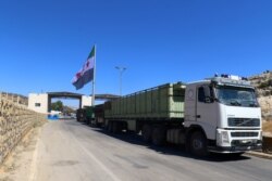 FILE - A Free Syrian Army flag flies at Bab al-Hawa crossing point in Syria, July 8, 2017.