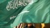 FILE - An embassy honor guard member is covered by the flag of Saudi Arabia, in Washington, March 22, 2018. The kingdom, on Feb 27, 2024, executed seven individuals for "creating and financing terrorist organizations and entities," its interior ministry said.