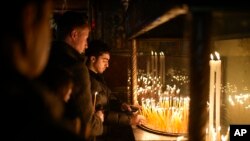 Faithful pray at the Church of the Nativity, traditionally believed to be the birthplace of Jesus, in the West Bank city of Bethlehem, Dec. 24, 2024. 