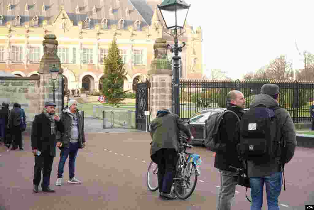 Journalists and members of the public queue