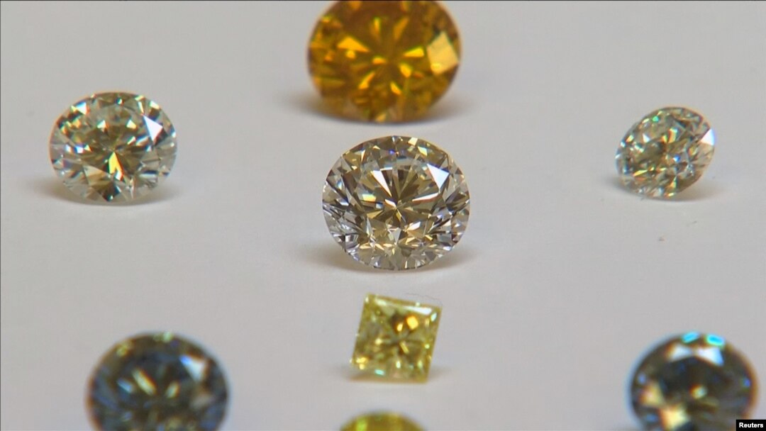 FILE - A still image from video shows coloured synthetic diamonds on display at De Beers' International Institute of Diamond Grading and Research in Maidenhead, Aug. 15, 2016. 