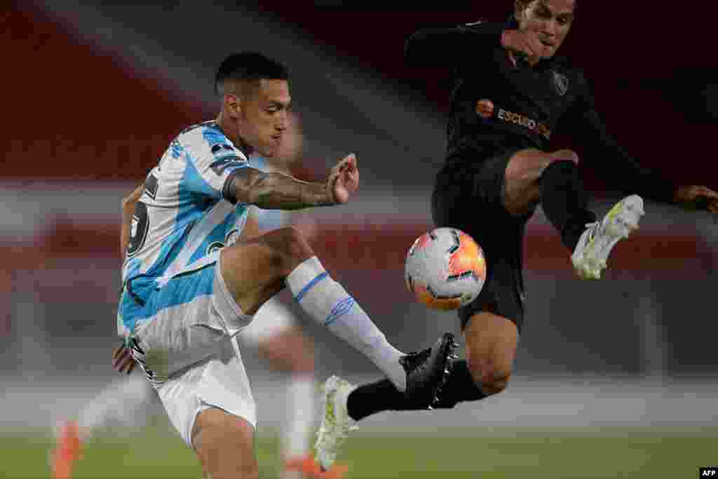Argentina&#39;s Atletico Tucuman Yonathan Cabral (L) and Argentina&#39;s Independiente Lucas Romero vie for the ball at the Libertadores de America Stadium in Buenos Aires, on Oct. 29, 2020.