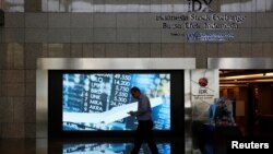 A man walks past screen at the Indonesia Stock Exchange building in Jakarta, Indonesia, Sept. 6, 2018. 