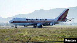 An aircraft, chartered by the U.S. State Department to evacuate government employees and other Americans from the novel coronavirus threat in the Chinese city of Wuhan, arrives at March Air Reserve Base in Riverside County, California, U.S.