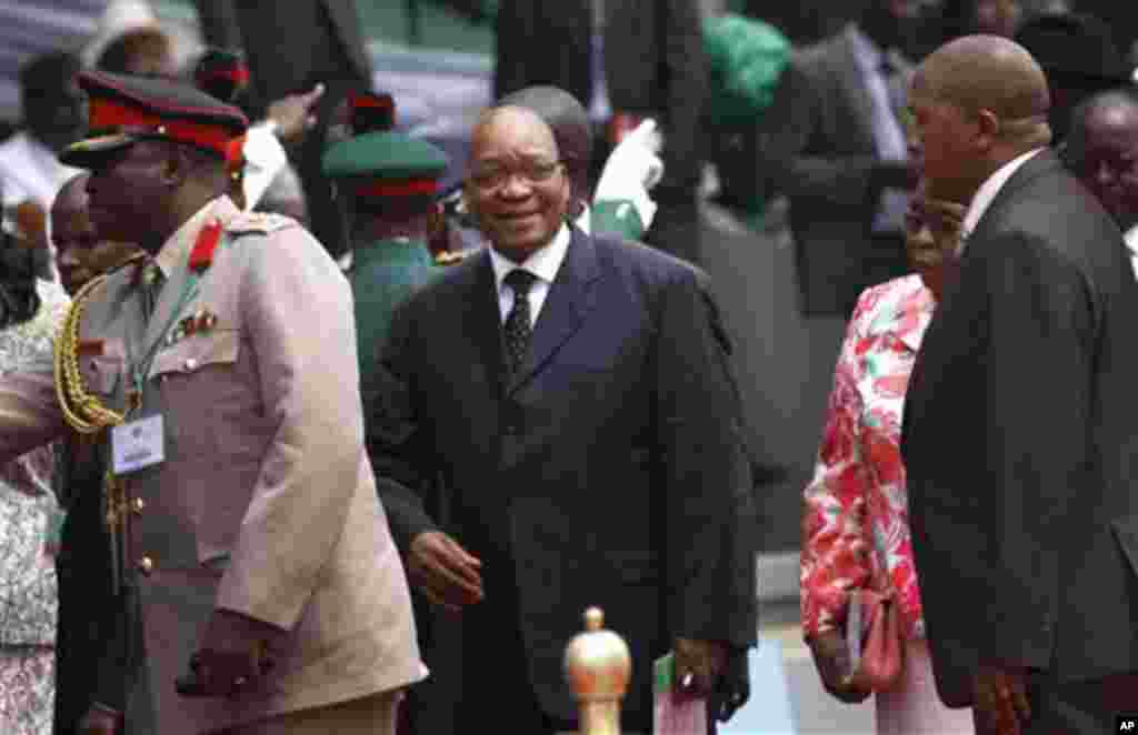 South Africa President Jacob Zuma, center, arrives for the inauguration ceremony of Nigeria President Goodluck Jonathan at the main parade ground in Nigeria's capital of Abuja, Sunday, May 29, 2011. Jonathan was sworn in Sunday for a full four-year term a