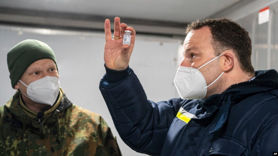 Jens Spahn, German Minister of Health, with Julian Brederlow, senior staff pharmacist, at Bundeswehr pharmacy in Quakenbrueck, Germany, May 14, 2021. He said the national average infection rate fell to 96.5 per 100,000, its lowest level since March 20.
