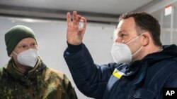 Jens Spahn, German Minister of Health, with Julian Brederlow, senior staff pharmacist, at Bundeswehr pharmacy in Quakenbrueck, Germany, May 14, 2021. He said the national average infection rate fell to 96.5 per 100,000, its lowest level since March 20. 