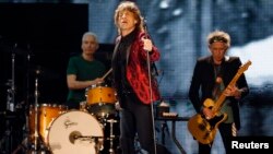 FILE - Mick Jagger (C), Charlie Watts (L) and Keith Richards of the Rolling Stones perform during a concert in Abu Dhabi, Feb. 21, 2014.