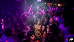 People drink on the dance floor shortly after the reopening at The Piano Works in Farringdon, in London.&nbsp;Thousands of young people plan to dance the night away at &#39;Freedom Day&#39; parties when almost all coronavirus restrictions in England are to be scrapped.
