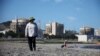 FILE - Hwang Bun-hee takes a walk on a seashore as Wolseong Nuclear Power Plant is seen in the background in Gyeongju, South Korea, Aug. 21, 2022. South Korea approved the construction of two nuclear reactors on its east coast on Sept. 12, 2024.