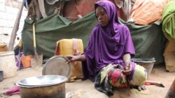 FILE: Somali young girl cooks food outside their makeshift home inside a refugee camp in Mogadishu, Somalia, Tuesday, Sept. 20, 2016. A new U.N. report says five million people are not getting enough food, on the chaotic Horn of Africa.