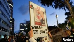 FILE - Protesters hold placards of Israeli child hostages outside the Tel Aviv offices of Nations International Children's Emergency Fund in Tel Aviv, Israel, November 20, 2023