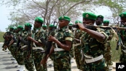 FILE — Burundian soldiers, part of the African Union troops, march at their base in Mogadishu, Somalia, Jan. 24, 2011. The Africa Union Peace and Security Council has approved Somalia's request for a three-month pause of the withdrawal of 3,000 peacekeepers.