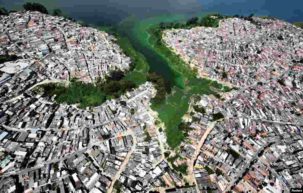 An aerial view shows illegally-built slums on the border of the polluted water of Billings reservoir in Sao Paulo, Brazil.