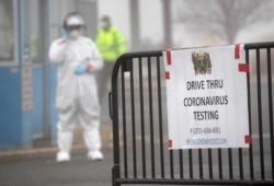 STAMFORD, CT - MARCH 20: A sign sits on a barrier at a coronavirus (COVID-19) drive thru testing location operated by Murphy Medical Associates at Cummings Park on March 20, 2020 in Stamford, Connecticut. We are still at the beginning of this public…