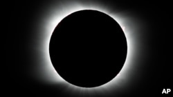 FILE - The moon covers the sun during a total solar eclipse as seen in Piedra del Aguila, Argentina, Dec. 14, 2020. 