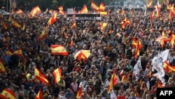 A banner depicting Spanish Prime Minister Pedro Sanchez and his wife Begona Gomez next to the word "guilty" is seen among Spanish flags during a demonstration to protest against the ruling government, in Madrid on Oct. 20, 2024. 