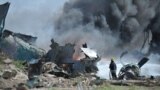 Firefighters attempt to extinguish the fire at Mogadishu&#39;s Aden Adde International Airport in Somalia after an Ethiopian Air Force aircraft crashed upon landing. (Photo provided by AMISOM)