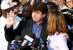 FILE - Former Illinois Governor Rod Blagojevich, with his wife Patricia at his side, speaks to the media in Chicago before reporting to federal prison in Denver, March 14, 2012.