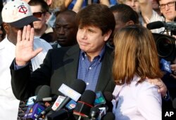 FILE - Former Illinois Governor Rod Blagojevich, with his wife Patricia at his side, speaks to the media in Chicago before reporting to federal prison in Denver, March 14, 2012.
