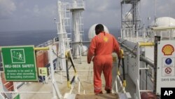 An unidentified Shell worker pictured aboard the Bonga offshore oil vessel off the coast of Nigeria, Dec. 26, 2011. 