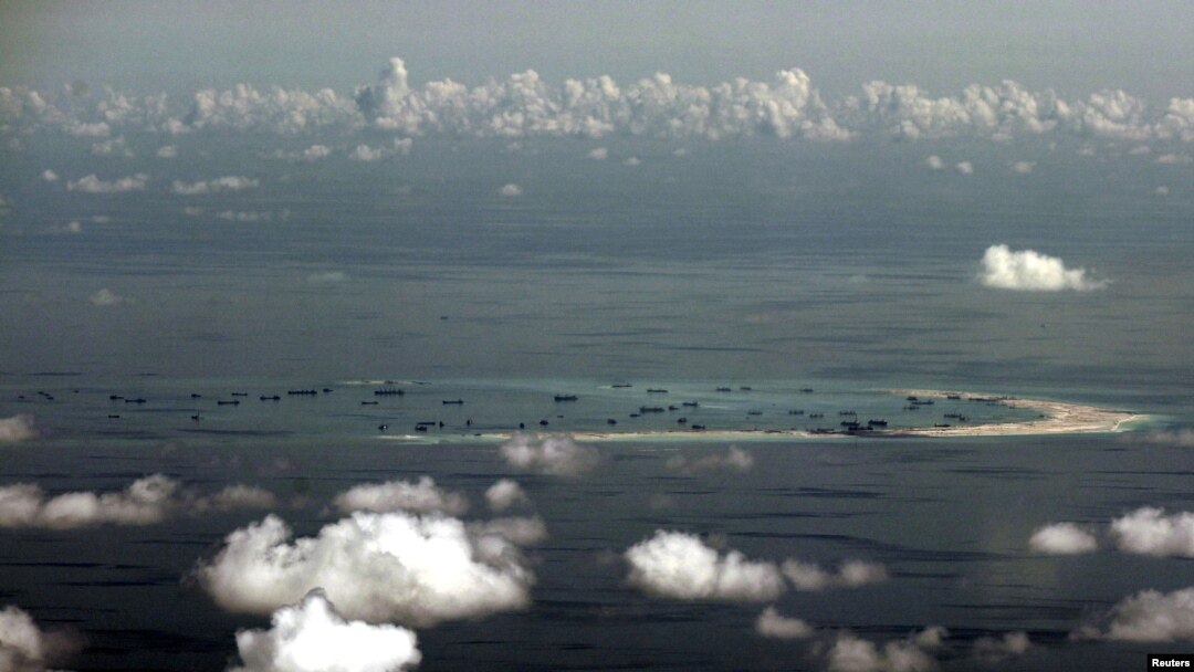 FILE - An aerial photo taken though the window of a Philippine military plane shows the land reclamation by China in the Spratly Islands in the South China Sea, west of Palawan, Philippines, May 11, 2015.