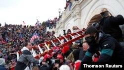 A pro-Trump mob storms the US Capitol during clashes with police, during a rally to contest the certification of the 2020 US presidential election results by the US Congress, in Washington, Jan. 6, 2021.