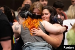 Abortion rights supporters react to the news that voters had rejected a state constitutional amendment that would have declared there is no right to abortion, during the Kansans for Constitutional Freedom election watch party in Overland Park, Kansas, U.S. August 2, 2022. (Evert Nelson/USA Today Network via REUTERS)