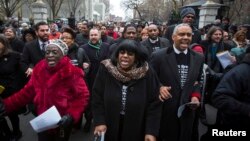 Members of the New York City Council exit the gates of City Hall as they perform a spontaneous protest in response to police violence in New York, Dec. 8, 2014., 