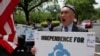 FILE - Demonstrators hold a protest in front of the State Department to urge the US and the international community to take action against China's treatment of the Uyghur people, May 5, 2021.