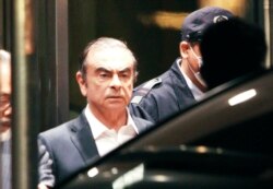 FILE - Former Nissan chairman Carlos Ghosn leaves the Tokyo Detention Center, in Tokyo, Japan, April 25, 2019.