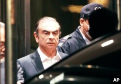 FILE - Former Nissan Chairman Carlos Ghosn leaves the Tokyo Detention Center in Tokyo, April 25, 2019.