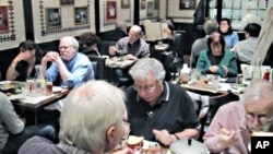 The dinnertime crowd gathers for a meal at the 2nd Avenue Deli.