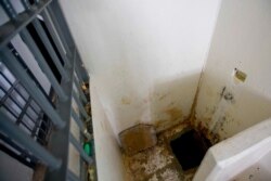 FILE - This photo shows the shower area where authorities claim drug lord Joaquin "El Chapo" Guzman slipped into a tunnel to escape from his prison cell at the Altiplano maximum security prison, in Almoloya, west of Mexico City, July 15, 2015.
