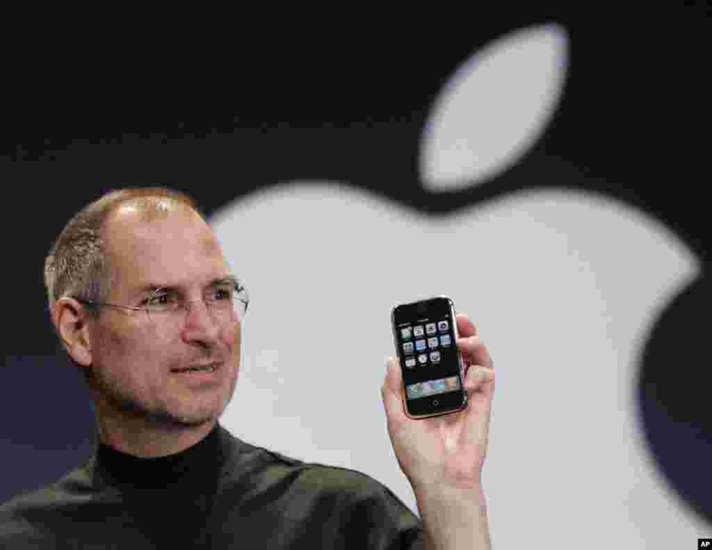 In this Jan. 9, 2007 file phtoo, Apple CEO Steve Jobs holds up an Apple iPhone at the MacWorld Conference in San Francisco. Apple Inc. on