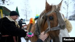 In the village of Vosava, Belarus, men prepare a horse and a sleigh to celebrate the New Year on January 13 according to the Julian calendar, 2017. 