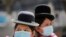 Aymara indigenous women wearing protective masks are seen at the Plaza Murillo during a celebration marking the 195th anniversary of Bolivia foundation at the presidential palace, amid the COVID-19 outbreak, in La Paz, Bolivia, Aug. 6, 2020.