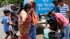 Indians collect drinking water from a mobile water tanker on a hot summer day in Prayagraj, India, Saturday, June 15, 2019. Many parts of India are experiencing extreme heat conditions. 