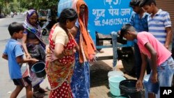 Indians collect drinking water from a mobile water tanker on a hot summer day in Prayagraj, India, Saturday, June 15, 2019. Many parts of India are experiencing extreme heat conditions.