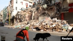 A rescue dog walks near rubble of damaged buildings due to the massive explosion at Beirut's port area, Lebanon September 3, 2020. REUTERS/Mohamed Azakir