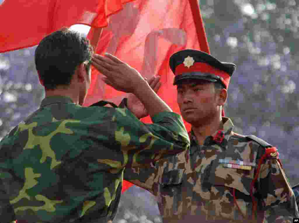 Re-enacting a scene from the 2006 peace accord when the civil war ended