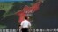 FILE - A screen shows a news program reporting in Tokyo about North Korea's missile firing from Wonsan, center, June 8, 2017.