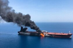 FILE - A picture from Iranian News Agency ISNA, June 13, 2019, reportedly shows fire and smoke billowing from Norwegian owned Front Altair tanker said to have been attacked in the waters of the Gulf of Oman.