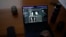 The computer screen of Santiago Barros shows old photographs of couple Maria Eugenia Gonzalez and Nestor Oscar Junquera, who disappeared during dictatorship, above AI-generated images of what their stolen son might look like today, in Buenos Aires, Argentina,  Aug. 2, 2023. 