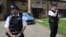 Police officers outside home raided in Stratford, east London, July 5, 2012.