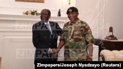 In this handout photos, President Robert Mugabe poses with General Constantino Chiwenga at State House in Harare, Zimbabwe, Nov. 16, 2017. 