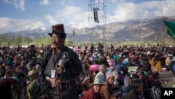 FILE - Buddhist devotees wait to listen to the Dalai Lama's teachings on the fifth day of Kalachakra near Leh, India.