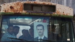 People ride on a bus as they head to a polling station to cast their vote, during the presidential elections, in Damascus, Syria May 26, 2021.