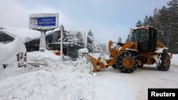 A plow clears snow after a heavy winter storm in Tahoe City, California, Jan. 11, 2017. The storm that struck California has moved to the Midwest, where it is leaving freezing rain and ice.